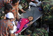 Rescuers carry Reshma Begum from the rubble of a building that collapsed in Savar, near Dhaka, Bangladesh, Friday, May 10, 2013. Rescue workers in Bangladesh freed the woman buried for 17 days inside the wreckage of a garment factory building that collapsed, killing more than 1,000 people. Soldiers at the site said her name was Reshma and described her as being in remarkably good shape despite her ordeal. (AP Photo) 