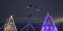  In this July 27, 2012 file photo, British stuntman Mark Sutton parachutes into the Olympic Stadium, dressed as James Bond, during the Olympic Games 2012 Opening Ceremony. Online extreme sports broadcaster Epic TV says Sutton died this week in the Swiss Alps during a gathering it had organized involving 20 wing suit pilots who were being filmed as they jumped from helicopters. (AP Photo/PA, Lewis Whyld, File)