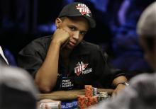 Phil Ivey looks up during the World Series of Poker at the Rio Hotel and Casino in Las Vegas. The Borgata Hotel Casino & Spa is suing Ivey, considered one of the best poker players in the world, claiming he won $9.6 million in a card-cheating scheme in baccarat. (AP Photo/Laura Rauch, File)