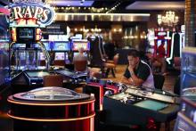 In this Sept. 24, 2015, photo, a man plays an electronic roulette game at the Downtown Grand hotel and casino in Las Vegas. As gamblers move away from traditional slot machines, game-makers and casinos are looking at new ways to keep people playing. (AP Photo/John Locher)