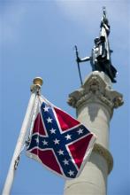 A Confederate flag flies next to the Alabama Confederate Memorial on the grounds of the Alabama Capitol building in Montgomery, Ala., Monday, June 22, 2015. (Albert Cesare/The Montgomery Advertiser via AP)