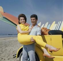 In this 1963 file photo, singer Frankie Avalon and actress Annette Funicello are seen on Malibu Beach during filming of "Beach Party," in California in 1963. Walt Disney Co. says, Monday, April 8, 2013, that former "Mouseketeer" Funicello, also known for her beach movies with Avalon, has died at age 70. (AP Photo/File)