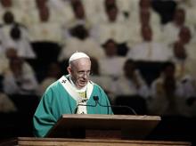 Pope Francis reads his homily while celebrating high Mass at Madison Square Garden, Friday, Sept. 25, 2015, in New York. (AP Photo/Julie Jacobson, Pool)