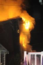 Flames pour out of the front of the home at 235 Pierce St., in Pottsville, Pa., early Monday morning, May 13, 2013. Authorities said the fire killied four young children, their father and another relative. (AP Photo/Republican-Herald,Nick Meyer )