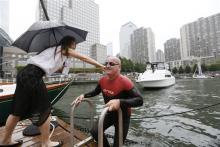  Martin Strel is greeted by his daughter Nina after completing his "Clean Water Swim" from the Statue of Liberty to Manhattan's North Cove Marina, operated by Island Global Yachting, on Thursday, Sept. 10, 2015, in New York. (Photo by Stuart Ramson/Invision for Martin Strel/AP Images)
