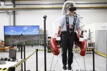 In this Feb. 9, 2016 photo, test pilot Michael van der Vliet operates a flight simulator at the Martin Aircraft Co. headquarters in Christchurch, New Zealand. The company says it’s close to commercial liftoff, but the man who started it fears his vision of a personal jetpack will remain grounded. (AP Photo/Nick Perry)