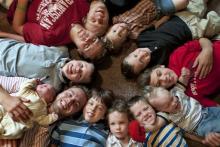In this Aug. 6, 2013, photo, the 12 Schwandt brothers pose for a photo in their home in Rockford, Mich. Clockwise from bottom left are, Tyler, 21, holding Tucker, 2 days, Vinny, 10, Drew, 16, Zach, 17, Charlie, 3, Calvin, 8, Brandon, 14, Luke, 19 months, Gabe, 6, Wesley, 5 and Tommy, 11. Jay and Kateri Schwandt welcomed their 12th child this week – and they’re all boys. (AP Photo/MLive.com, The Grand Rapids Press, Chris Clark) 