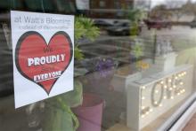 A window sign on a downtown Indianapolis florist, Wednesday, March 25, 2015, shows it's objection to the Religious Freedom bill passed by the Indiana legislature. Organizers of a major gamers' convention and a large church gathering say they're considering moving events from Indianapolis over a bill that critics say could legalize discrimination against gays. (AP Photo/Michael Conroy)