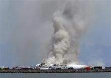 Smokes rises from Asiana Flight 214 after it crashed at San Francisco International Airport in San Francisco, Saturday, July 6, 2013. (AP Photo/Bay Area News Group, John Green)