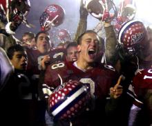 In this Dec. 8, 2001 file photo, Neshaminy quarterback Jason Waiter, center, celebrates with teammates after their 21-7 victory over Woodland Hills to claim the Class AAAA state title in Hershey, Pa. (AP Photo/Chris Gardner)