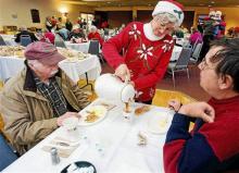 In this December 2011 photo, Connie Howe pours coffee for Ronald Read, left, and Dave Smith during the Charlie Slate Memorial Christmas breakfast at the American Legion in Brattleboro, Vt. (AP Photo/Brattleboro Reformer, File)
