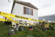 Bicycles sit behind the home of Blake and Blaine Romes in Ottawa, Ohio, Friday, May 10, 2013. Two teenage brothers who had been reported missing were found dead after a third teen pointed authorities to their bodies before he was taken into custody, officials said. The three teens, 14-year-old Blaine Romes, 17-year-old Blake Romes and 17-year-old Michael Fay, lived together with their mothers inside a trailer home in Ottawa in northwest Ohio, neighbors said. The three had been the subject of an Amber Alert 