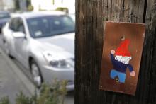 A hand painted portrait of a gnome is shown on a utility pole in Oakland, Calif.