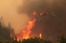 Helicopters battle the 64,000 acre Beaver Creek Fire on Friday, Aug., 16, 2013 north of Hailey, Idaho. A number of residential neighborhoods have been evacuated because of the blaze.(AP Photo/Times-News, Ashley Smith)