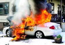 Chyvonne Drucker's Ford Taurus burns on East Eighth Street in Bloomsburg late Thursday morning.