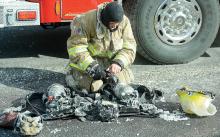 A Danville firefighter attempts to turn off some of his equipment after it froze Tuesday afternoon on Ash Street in the Borough. (Press Enterprise/Keith Haupt)