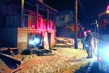 Bloomsburg firefighters investigate following a furnace explosion at the Millville Road home of Phil and Brenda Vaughn early Wednesday morning. 