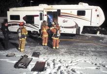 (Press Enterprise/Bill Hughes) Firefighters from Espy, Lightstreet and Orangeville extinguish a fire in an RV parked on a property along Hidlay Church Road in North Centre Township early Thursday morning.