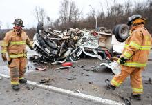 Espy rescue crews prepare to clean up debris scattered from a Ford F-450 after the driver collided with the back end of a low-boy trailer carrying a crane Wednesday morning along Interstate 80 eastbound near the Lightstreet exit. (Press Enterprise/Keith Haupt)