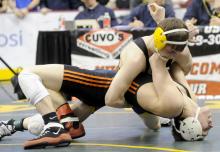 Southern Columbia's Blake Marks, background, rolls Fort LeBoeuf's Taylor Harrington during a 152-pound preliminary match Thursday morning during the PIAA, Class AA Wrestling Championships in Hershey. 