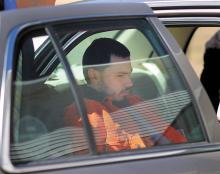 Murder suspect Cea Jay Chattin, of Benton, sits in the backseat of a police car following his arraignment at District Court in Millville on Sunday afternoon.