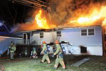 Firefighters work outside a raging fire at 290 W. 11th St., Bloomsburg. (Keith Haupt/Press Enterprise)