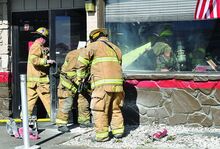 Press Enterprise/Jimmy May Firefighters inside and outside of Denny’s restaurant in Scott Township work to gain access to a fire inside of the wall Wednesday morning. 