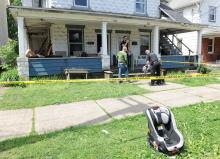 Berwick police work inside the tape line at this home at 811 Mulberry Street in Berwick Thursday after raiding the home with a warrant. (Press Enterprise/Keith Haupt)