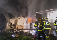 Firefighters from Berwick battle a mobile home fire late Thursday night in the trailer park along Columbia Boulevard in Briar Creek Borough. (Press Enterprise/Jimmy May)