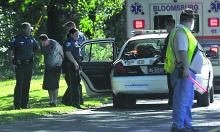 Police escort a man to a police cruiser along Fort McClure Boulevard in Bloomsburg after talking him out of the river Wednesday afternoon. (M.J. Mahon/Press Enterprise)