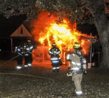 Firefighters train a hose on a shed at 1613 Orange St., Berwick. (Press Enterprise/Tom Adams)