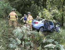 Espy and Lime Ridge firefighters prepare to stabilize this car and remove the driver after a cash along the Old Berwick Road at Naus Way in South Centre Township Tuesday afternoon. (Press Enterprise/Keith Haupt)