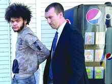 Joseph Ten Eyck is escorted out of District Judge Russell Lawton's court by Trooper Justin Kressler Wednesday morning. Ten Eyck turned himself in and was arraigned on attempted homicide charges.
