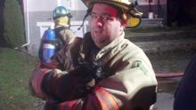 Bloomsburg firefighter Jeremy Fowler holds a cat another firefighter pulled from a fire at 259 Drinker St. (Leon Bogdan/Press Enterprise)