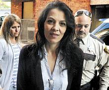 Maria Sanutti-Spencer is escorted into the Columbia County Courthouse in Bloomsburg, on Monday morning, for the start of jury selection for her murder trial. (Press Enterprise/Bill Hughes)