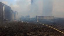 Firefighters work to extinguish a barn blaze near Northwest Area High School. (Press Enterprise/Leon Bogdan)