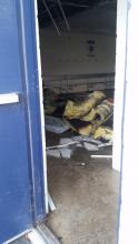 Charred insulation and ceiling tiles can be seen on the floor of the visitor's field house at Crispin Field, after a malfunctioning furnace caught fire.