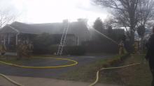 Firefighters work to put out a blaze in Scott Township Friday afternoon.