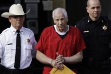 Jerry Sandusky, center, is shown in this file photo from a previous court appearance.