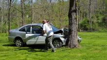 Two men clean up debris from an accident Monday afternoon in Buckhorn. (Press Enterprise/Julye Wemple)