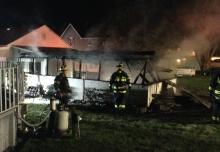 Firefighters work to douse a fire in a carport behind 1227 Ferris Ave. early Thursday morning. (Press Enterprise/Peter Kendron)