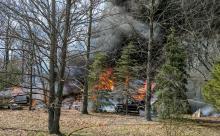 A fire burns at a home along Southern Drive near Rohrbach's Farm Market. (Press Enterprise/Jimmy May)