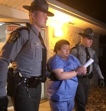 Susan Schwartz/Press Enterprise State Police escort Adrian Oswaldo Sura Reyes to a vehicle so he can be arraigned early Sunday morning. Sura Reyes allegedly confessed to driving into a crowd, killing one woman and injuring 17, then driving to Nescopeck and murdering his mother.