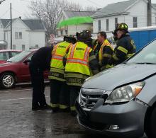 Berwick EMTs and firefighters shield crash victim Nivea Pena-Colon as she is taken to a waiting ambulance following a Monday morning crash.