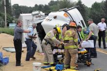 (Press Enterprise/Harry Watts) Rescuers help an injured woman after her husband's rig crashed in Madison Township Monday.