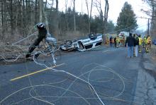 Crews work at the scene of an early morning accident on Mountain Road Monday morning. Ralpho Township officer Chris Dailey, 45, was injured in the crash.