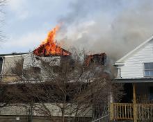 Flames roll out of the attic and roof area of a home on Ash Street in Danville Tuesday afternoon. (Press Enterprise/Chris Krepich)