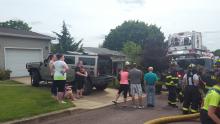 A crowd gathers outside a home on Hillside Drive in Berwick after a small dryer fire broke ou Sunday afternoon.