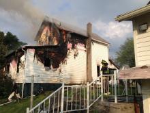 Fire burns in the rear section of a house on Pearl Street. (Press Enterprise/John-Erik Koslosky)