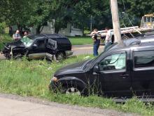 Firefighters and a state trooper examine a GMC SUV damaged in a Monday accident. The Nissan it collided with is in the foreground of the photo. (Press Enterprise/Bill Hughes)